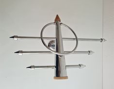 a metal sculpture with several different types of sticks attached to it