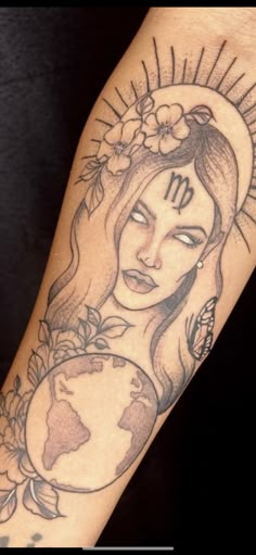 a woman's arm with a tattoo on it and the sun above her head