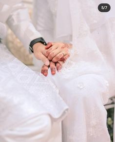 two people are holding hands with each other