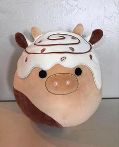 a stuffed animal pig with a hat on it's head