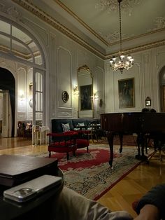 a living room filled with furniture and a grand piano