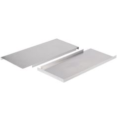 two metal trays sitting next to each other on top of a white surface,