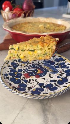 a slice of quiche on a plate next to another dish