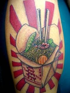 a tattoo with noodles and chopsticks in a box