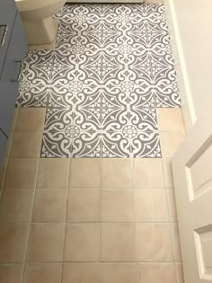 a bathroom with a toilet, sink and tiled floor