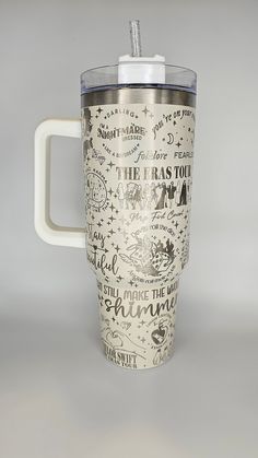 a travel mug with writing on it