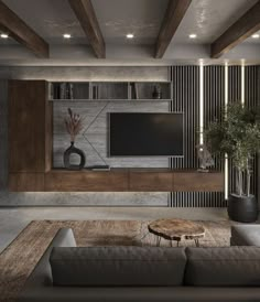 a living room with a couch, table and television on the wall in front of it