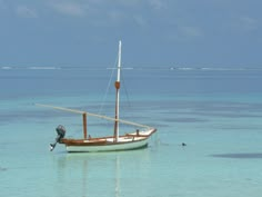 a small boat floating on top of a body of water