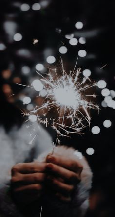 a person holding a sparkler in their hand