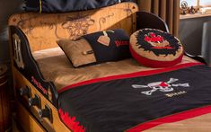 a bed with pirate themed sheets and pillows