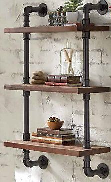 two shelves with pipes and books on them in front of a white brick wall next to a potted plant