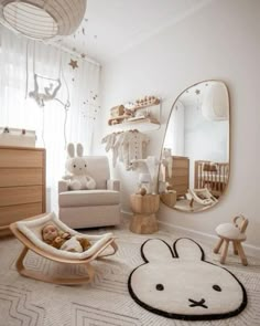 a baby's room with white walls and furniture