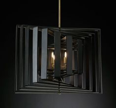 a chandelier hanging from the ceiling in a room with black walls and flooring