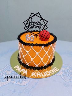 a birthday cake with an orange net and basketball on top