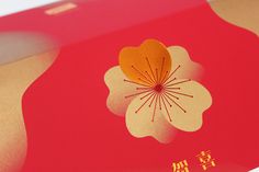 a red box with an orange flower on it