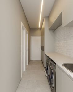 an empty laundry room with washer and dryer in the hallway next to the door