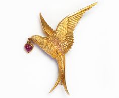 Tiffany & Co. France 20K Gold Ruby Diamond Bird Brooch. A rare Tiffany & Co. France 20 karat yellow gold ruby and diamond bird brooch as a flying Swallow with extended wings and split tail. The swallow is holding in its beak a ruby heart cabochon. Signed Tiffany & Co. France 20K. Approximate Measurements: 2.2" high by 1.8" wide. Flying Swallow, Ruby Heart, Genuine Love, Bird Brooch, Ruby Diamond, Birds Flying, 22k Gold, Tiffany & Co., Antique Jewelry