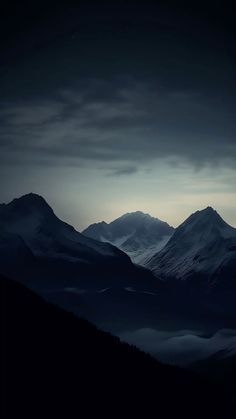 the mountains are covered in fog at night