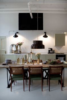 a dining room table with chairs and lights