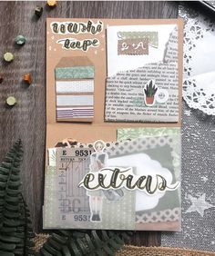 an assortment of paper and crafting supplies sitting on a wooden table next to a pine cone