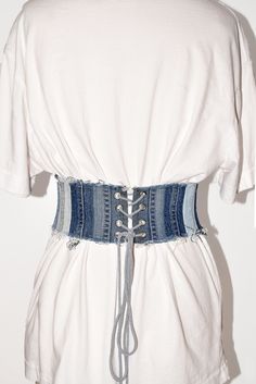 a white shirt with blue laces on the waist and an old jean corset