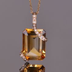 The Cache collection pendant features a Vibrant Emerald cut 13.23 carat Golden Citrine. The gemstone is set within double strap sets of 14K yellow gold consisting of .13 carats of blinding white Diamonds. Luxury Gemstone Jewelry, Luxury Citrine Octagon Jewelry, Luxury Octagon Citrine Jewelry, Elegant Orange Emerald Cut Jewelry, Necklace Pendant Ideas, Diamond Bracelet Design, Citrine Jewelry, Citrine Pendant, Diamond Jewelry Necklace