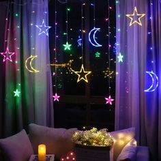 a living room with stars and moon lights on the window sill, next to a couch