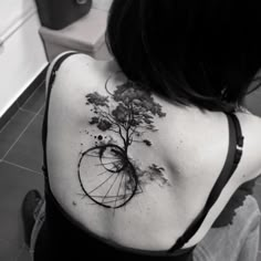 a woman with a tree tattoo on her back