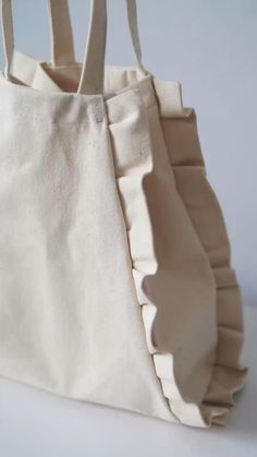 a white bag with ruffles on it sitting on a table