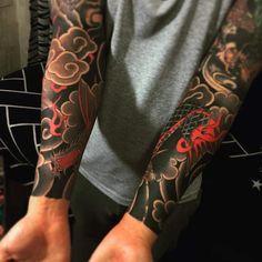 a man with tattoos on his arms and arm