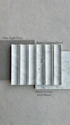 four pieces of white marble sitting next to each other