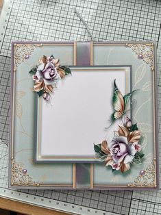 a close up of a card with flowers on it and a ruler next to it