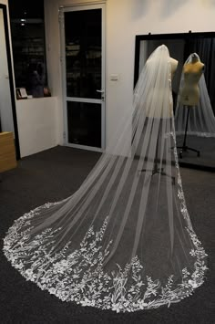 a bridal veil on display in front of a mannequin