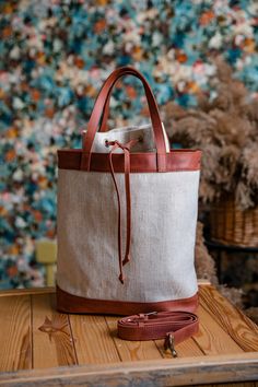 Leather canvas bag made by OKRA workshop is a unique item with very comfortable closure. It is an elegant canvas tote bag for any occassion - evryday bag, shopping bag, beach bag. It is made of very strong waterproof canvas (100% cotton) and cognac brown vintage leather. You can easily change the color of leather, we will make any combination for you. Our bag has a leather shoulder strap for your convenience. Dimensions of the bag: Height - 55 cm/22 inch Width - 30 cm/12 inch Depth - 12 cm/4.7 i Canvas Bucket Bag With Leather Handles For Everyday Use, Canvas Bucket Bag With Double Handle For Everyday Use, Cotton Canvas Bucket Bag With Leather Handles, Everyday Canvas Bucket Bag With Double Handle, Cotton Bucket Bag With Canvas Lining, Beige Canvas Bucket Bag For Daily Use, Rectangular Canvas Bucket Bag With Handles, Beige Canvas Satchel Bucket Bag, Everyday Canvas Bucket Bag