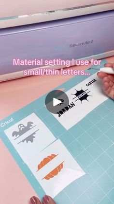 someone is cutting out some stickers on a piece of paper that says material setting use for small / thin letters