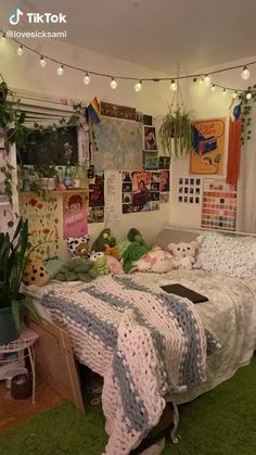 a bedroom with lots of plants and pictures on the wall