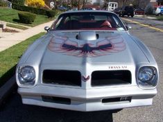 a silver pontiac car parked on the side of the road