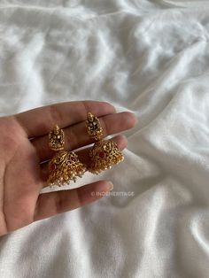 Step into the world of timeless elegance with our Jhumka Earrings. These exquisite earrings are a perfect blend of traditional design and contemporary style, making them a must-have accessory for any occasion. The jhumka style is inspired by traditional South Indian jewelry, known for its intricate craftsmanship and ornate designs. These earrings beautifully capture the essence of Indian culture and heritage, making them a timeless treasure to cherish. Whether you're attending a wedding, festival, or any special event, these Jhumka Earrings will complement your traditional attire flawlessly. They are also versatile enough to add a touch of elegance to your everyday look, making them a versatile addition to your jewelry collection. --------------------------------------------------------- C South Indian Jhumka, Bridal Temple Jewellery, Traditional Jewelry Indian, Indian Culture And Heritage, Temple Jewellery Jhumkas, Indian Accessories, Traditional Indian Jewellery, South Indian Jewelry, Traditional Earrings