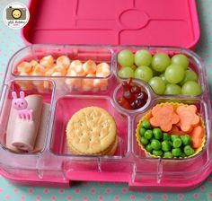 a bento box filled with different types of food and fruit in it's compartments