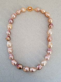 "This is a gorgeous pink white purple baroque pearl necklace made with 100 % natural cultured pearl and 18 kt yellow gold plated on sterling silver. Necklace Length: 17 \" Baroque Pearl: 15x15 to 12x12mm Italian made 925 Sterling Silver Clasp: 18mm The necklace is a beautiful statement piece with personality and really stands out. It is absolutely stunning and attractive. And it is easy to wear in any occasion. Pearl is the birthstone of june. Overtime, pearl has become the symbol of purity.   Please feel free to message me if you want to see more photos or make any modifications on the necklace. International Buyers Please Pay Attention: Import duties, taxes, and charges are not included in the item price or shipping cost. These charges are the buyer's responsibility. Please check with yo Pink Baroque Pearl Necklaces For Wedding, Pink Pearl Necklace With High Luster, Pink Baroque Pearl Necklace For Wedding, Purple Single Strand Pearl Necklace, Wedding Pink Baroque Pearl Necklaces, High Luster Pink Pearl Necklace, Wedding Pink Baroque Pearl Necklace, Elegant Pink Pear-shaped Necklace, Pink Pearl Charm Necklace For Formal Occasions