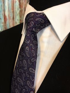 "Mens 100% silk purple paisley tie. This purple paisley necktie features a purple background with silver paisley pattern. Available as a extra long tie. Handmade from 100% silk, this special collection features a .75\" Eds Neckties logo at the bottom right front corner of every tie and a larger logo located on the tipping (Back of the tie). The label features the collection name (Nathaniel Alexandria) Named after my son Nathaniel and my daughter Alexandria. Expertly hand-made from 100% silk you Semi-formal Fitted Purple Suit And Tie Accessories, Elegant Purple Ties For Groom, Luxury Purple Tie For Formal Occasions, Elegant Semi-formal Paisley Print Ties, Luxury Classic Purple Ties, Purple Gothic, Make A Tie, Purple Paisley, Paisley Tie