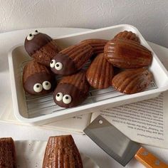 there are some cookies with googly eyes on them and a knife next to it