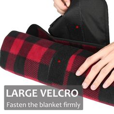 a woman's hand on the back of a black and red plaid blanket