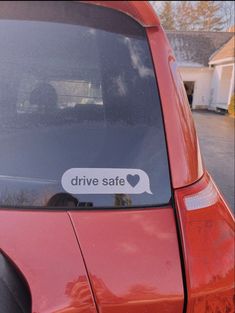 a red car with a sticker that says drive safe