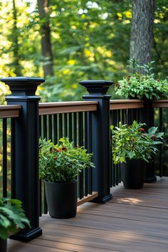 three black planters on a deck with trees in the background