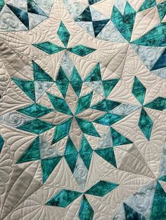 a blue and white quilt with an intricate design