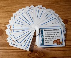 a bunch of cards sitting on top of a wooden table