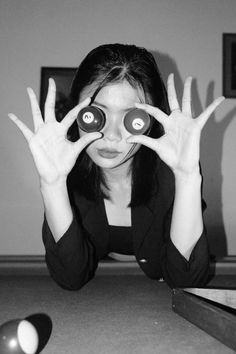 a woman is holding up two binoculars to look through the holes in her eyeglasses