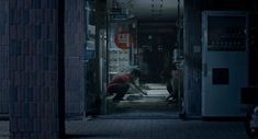 a man kneeling down in front of a doorway