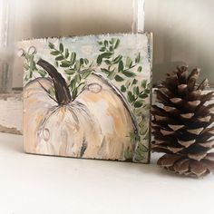 an acrylic painting of a pumpkin on a shelf next to a pine cone